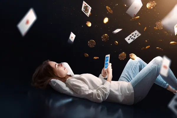 PHBINGO App — Enjoy seamless gaming on your smartphone A young woman relaxing with her phone while dynamic casino elements float around her, illustrating the smooth mobile experience offered by the PHBINGO app.
